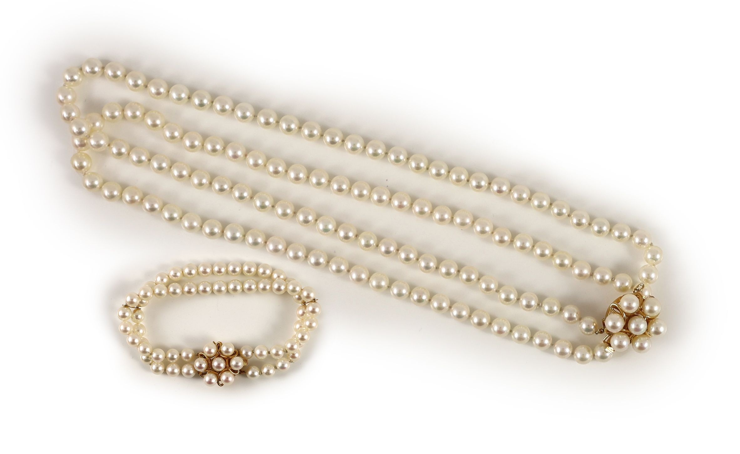 A modern continental double strand cultured pearl necklace with 14k gold and cultured pearl cluster set clasp and a matching bracelet